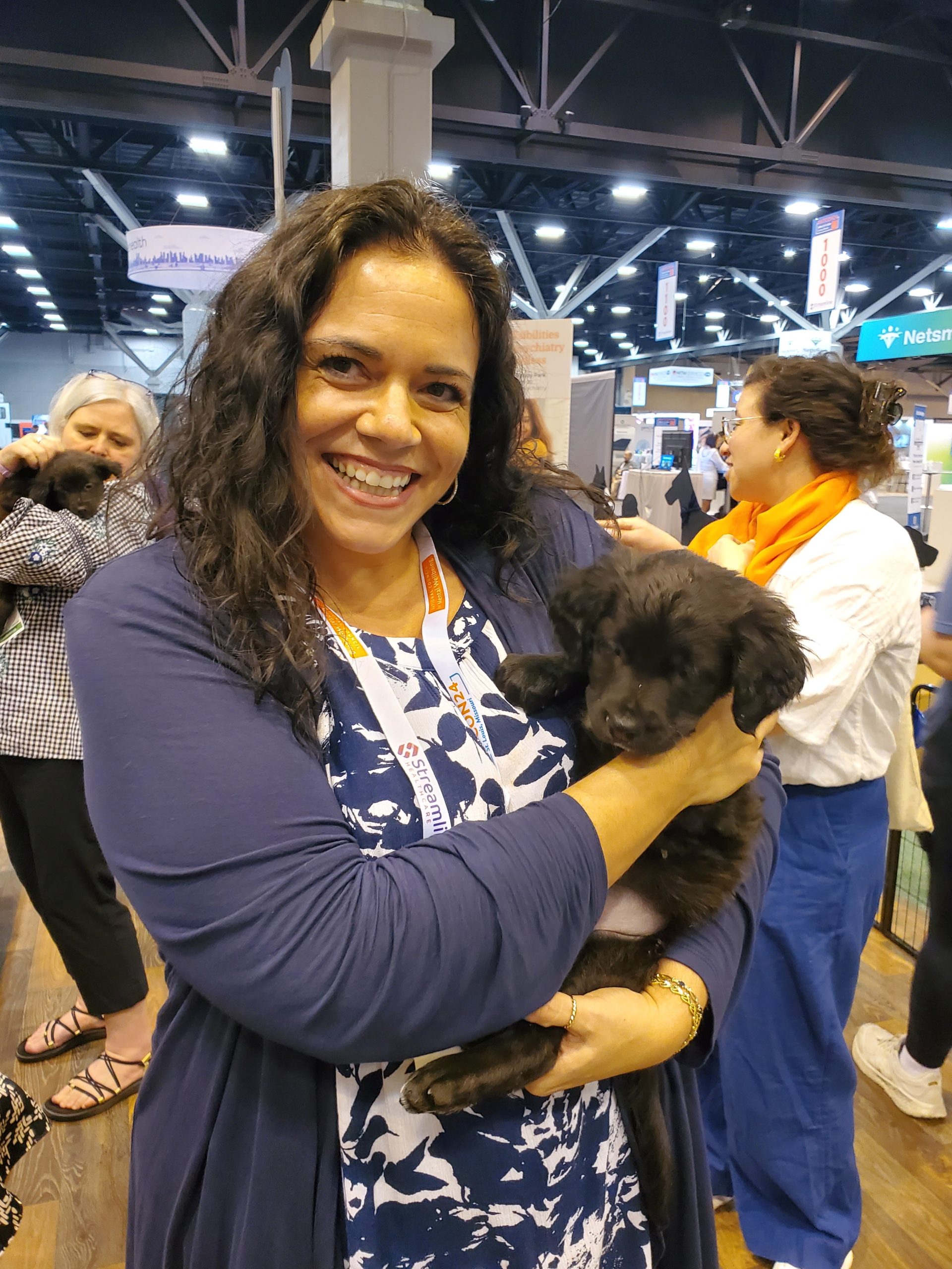Megan Howe holding at puppy at the NatCon24 Puppy Park.